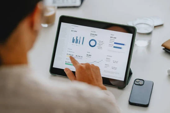 Reviewing financial charts and long-term investment information on a tablet
